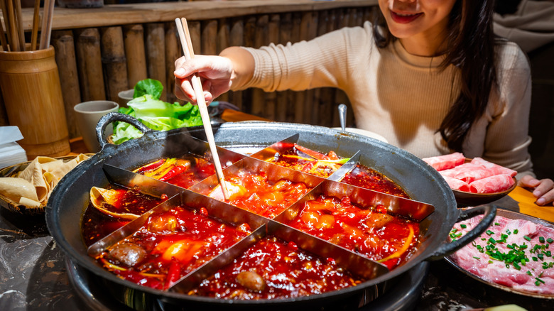 A diner eating Sichuan hot pot