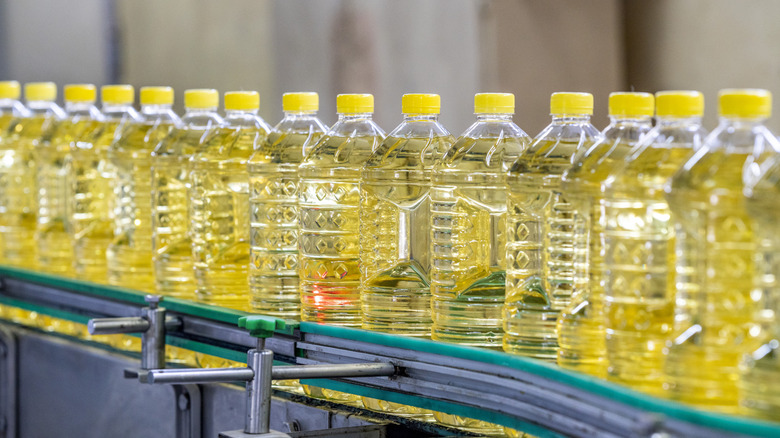 Sunflower oil bottles on a conveyor belt