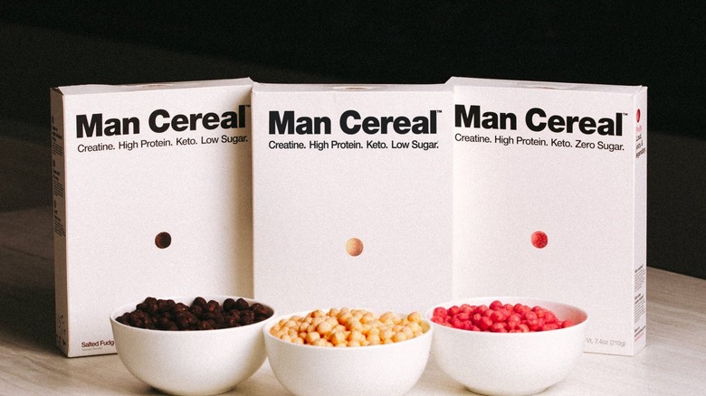 boxes of Man Cereal pictured alongside red and beige cereal pieces in white bowls