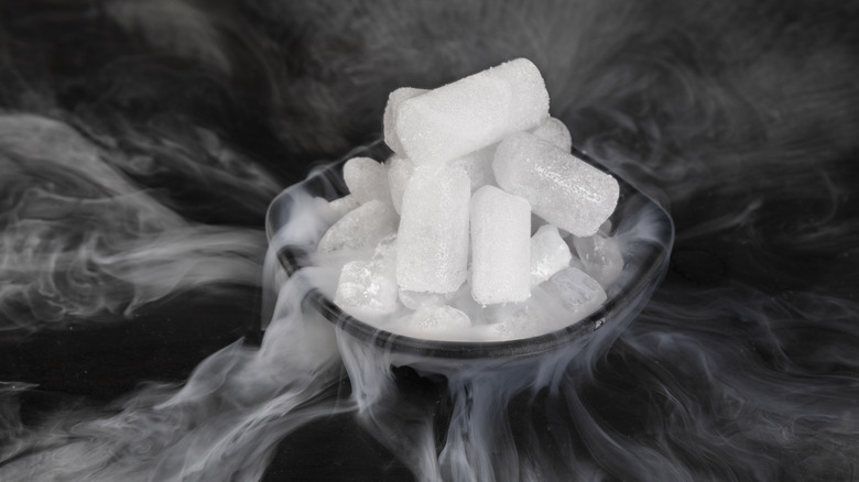 Dry ice in the bowl against a black background