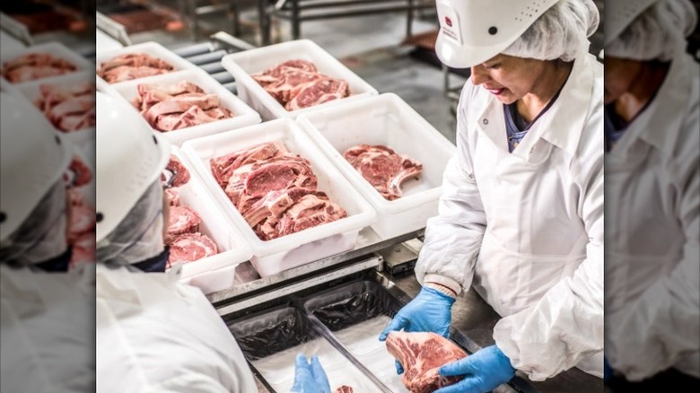 Workers at a Standard Meat plant.