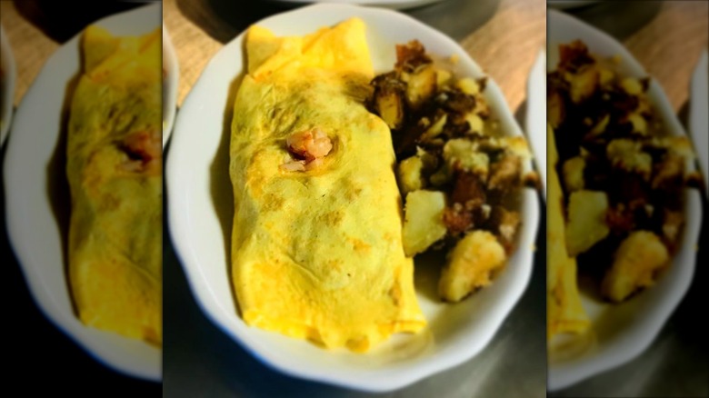 Lobster omelet with side of potatoes from Becky's Diner on a white platter