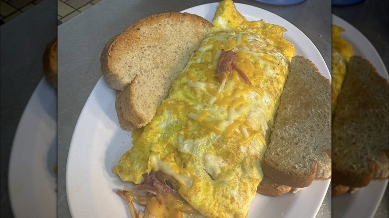 Omelet with side of toast from Woodees Cafe on a white platter