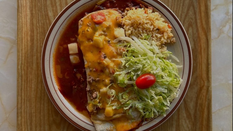 Omelet with potatoes and salad from The Frontier Restaurant with a white plate with a brown rim