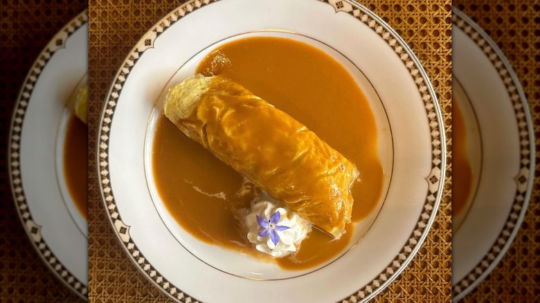 Tom Yum Crab Omelette from Thai Diner on a white plate with a decorative rim
