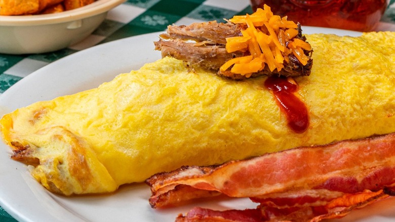 Pork BBQ Omelet with bacon from The Loveless Cafe on a white plate