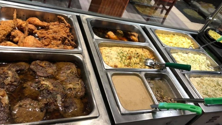 Buffet station at The Dinner Bell Cafe with fried chicken, mac and cheese, mashed potatoes, and beans