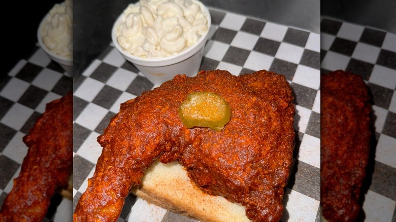 Nashville hot chicken on Texas toast with a side of mac and cheese on a checkered table