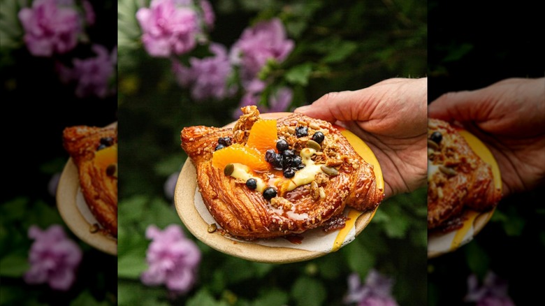 Peach, cream, and blueberries on top of croissant