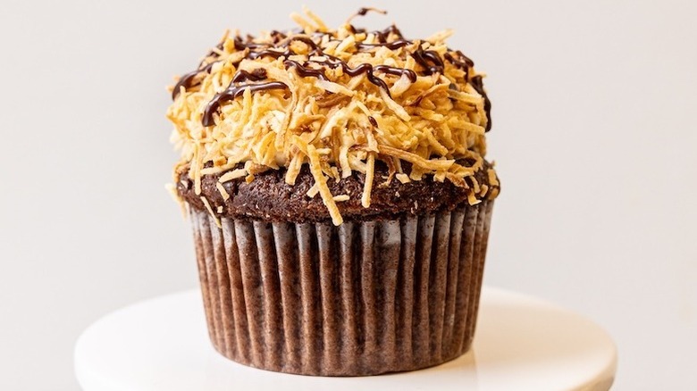 Chocolate cupcake with caramel buttercream and toasted coconut flakes