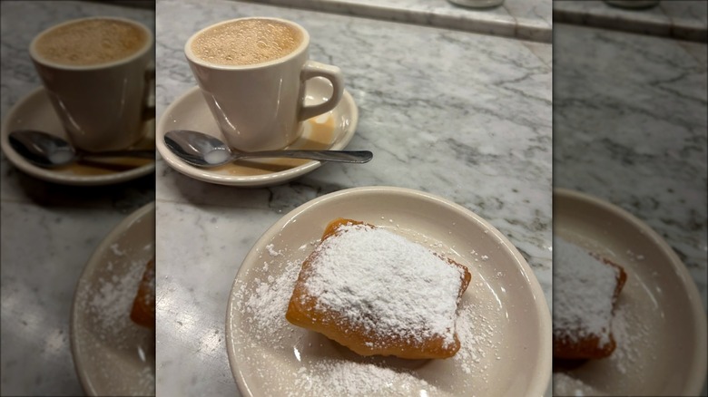 Beignets on plate with coffee at Morning Call Coffee Stand