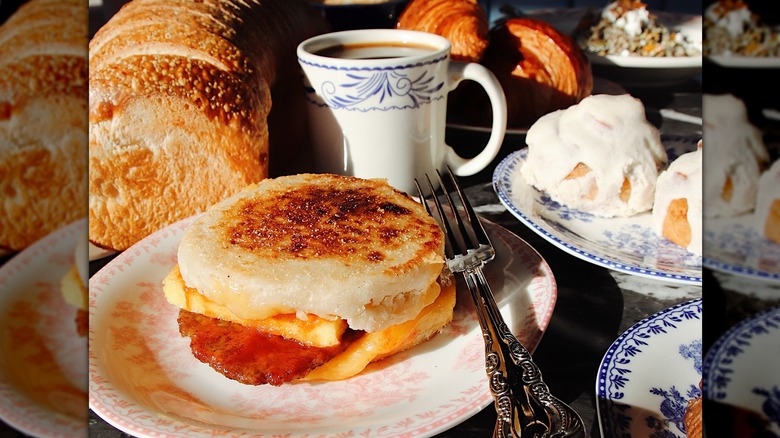 A lovely spread for breakfast with a coffee and breakfast sandwich
