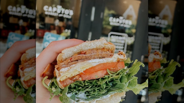 A breakfast sandwich with lettuce and tomato