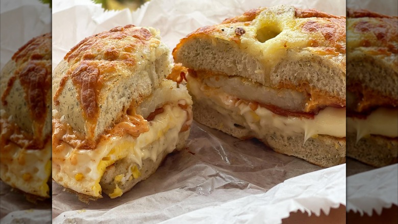 A bagel sandwich with hash brown and cheese