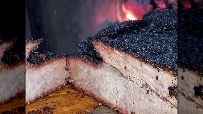 Heirloom Market BBQ Brisket sliced on wooden cutting board