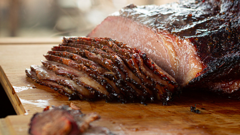 Juicy sliced brisket on a wooden cutting board