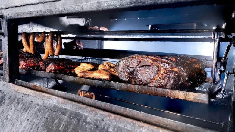 The Joint Brisket cooking in smoker with other meats