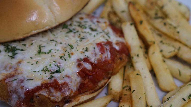 Chicken Parmesan sandwich with seasoned fries
