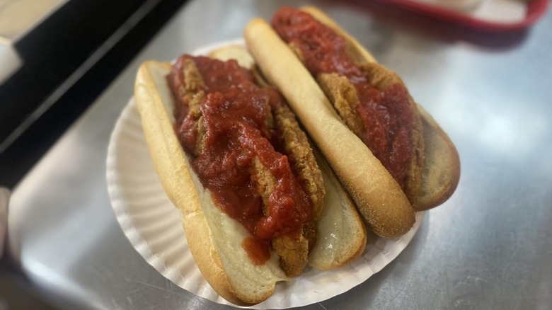 Two chicken parmigiana sandwiches on plate