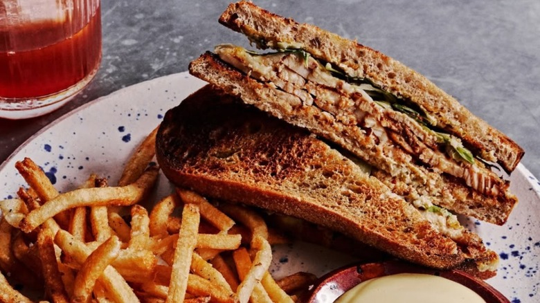Bayonet Swordfish Reuben sandwich on a white plate with fries