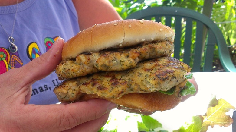 Person holding Nico's Pier at 38 Pier 28 Double Fish Burger