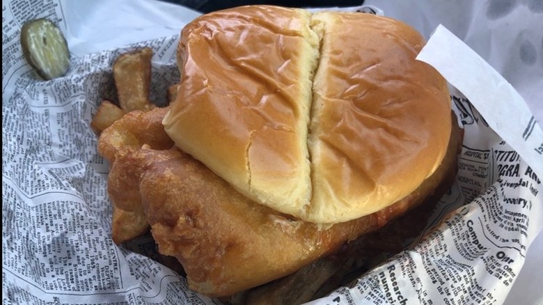 Codfather Cod Butty sandwich served with pickle slices and fries on butcher paper