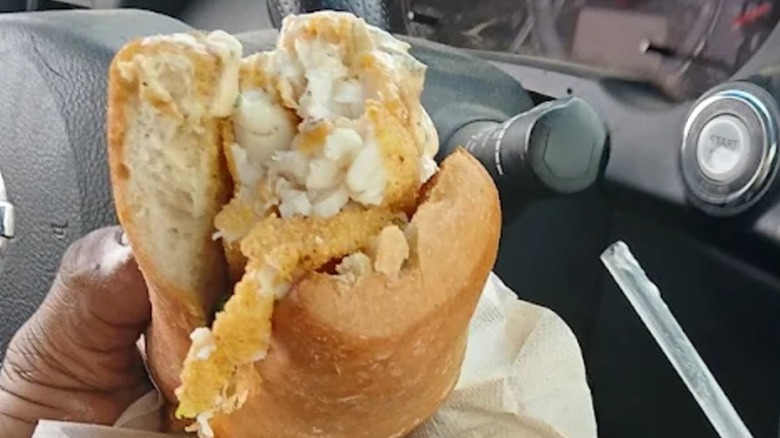 Person holding Off the Hook Eatery Fish Po´Boy