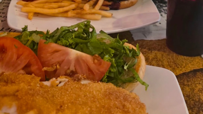 The Depot Fish Sandwichn on a white plate with a side of fries