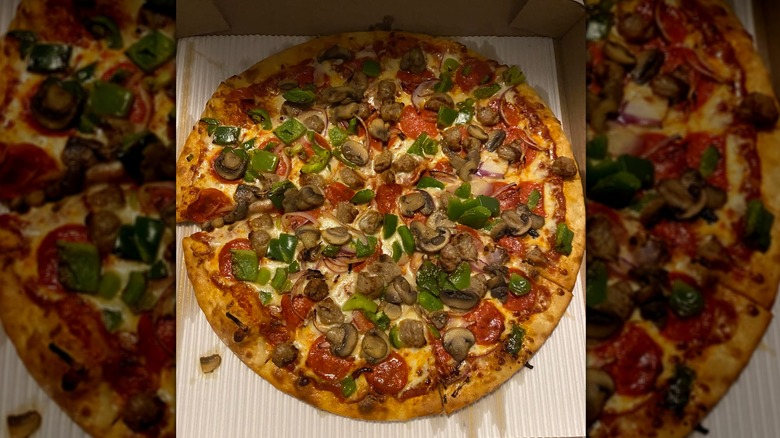 A Wawa pizza with vegetables and pepperoni sits in a box