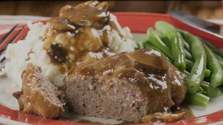 Two Seasons Cafe meatloaf plated with green beans, mashed potatoes, and gravy