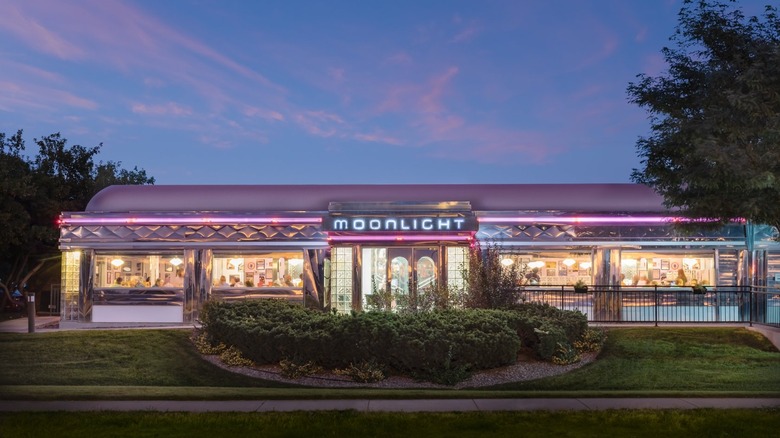 Exterior evening shot of Moonlight Diner with neon sign lit