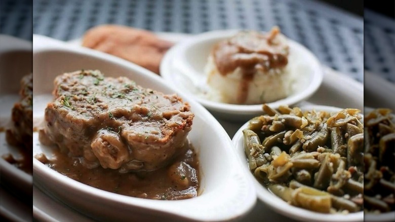 Five Sisters Blues Cafe Meatloaf entree in the background of a Meatloaf Monday Promo