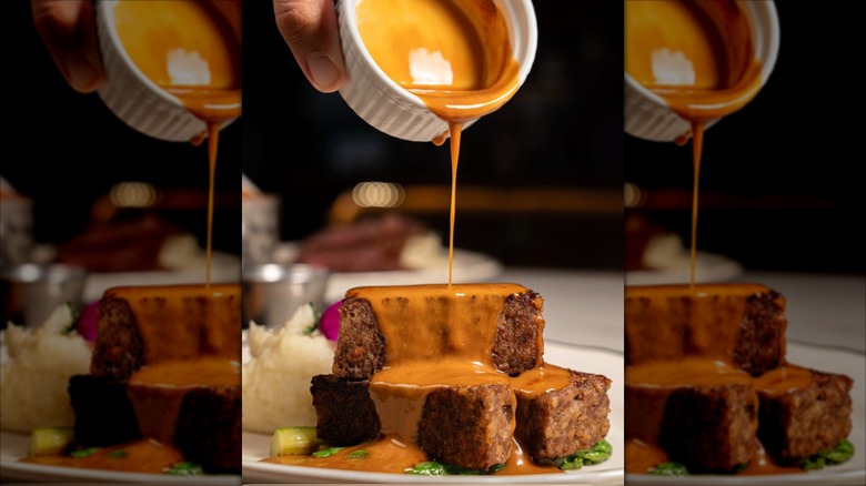The Butcher Bar Waikiki Meatloaf with Brown Gravy being poured over it