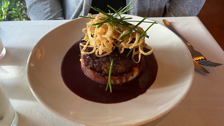 meatloaf plated at a table in a fine dining restaurant
