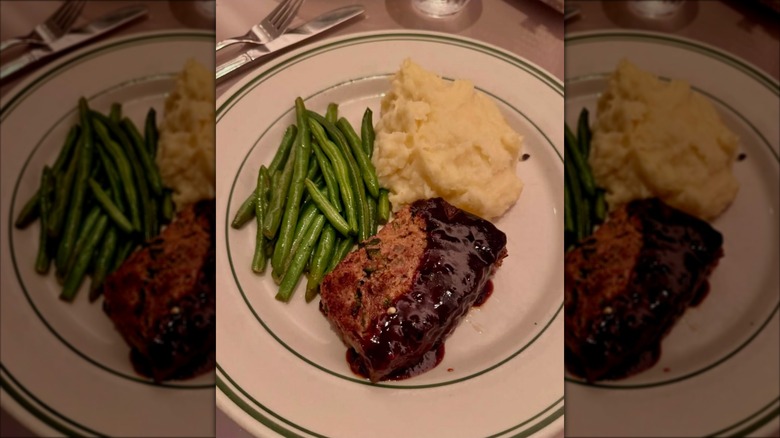 Meatloaf with sides of mashed potatoes and green beans