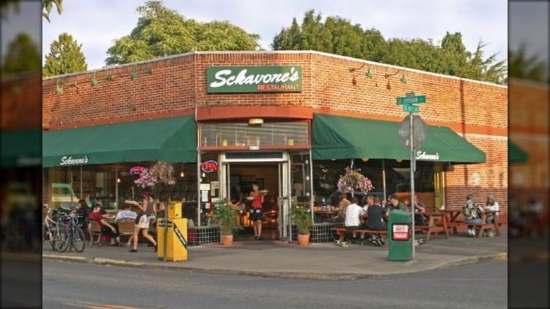 Sckavone's exterior with diners sitting outside dining al fresco on sidewalk tables