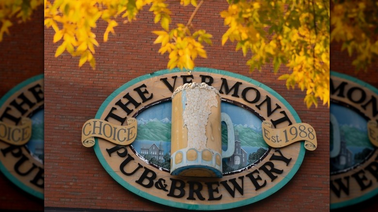 Exterior sign of the Vermont Pub and Brewery with yellow leaves in foreground