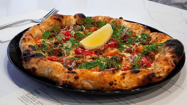 Pizza with lemon wedge