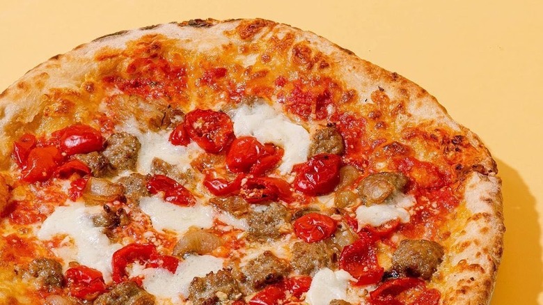 Pizza with ground beef and cherry tomatoes