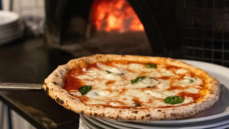 Margherita pizza next to oven
