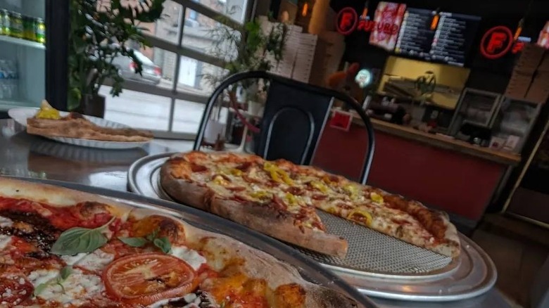 Two pizzas on pans