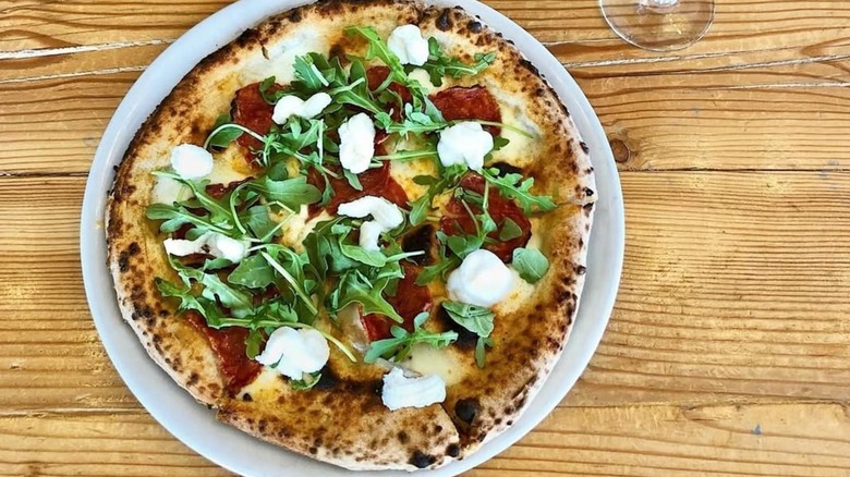 PIzza with fresh greens and mozzarella