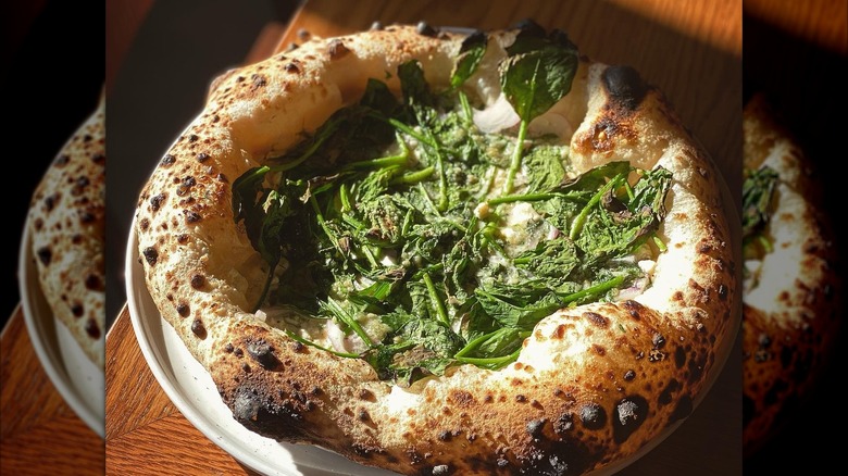 Pizza topped with greens