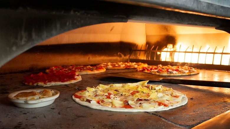 Pizzas in coal-fired oven