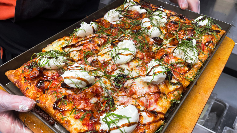 Rectangle pizza topped with burrata