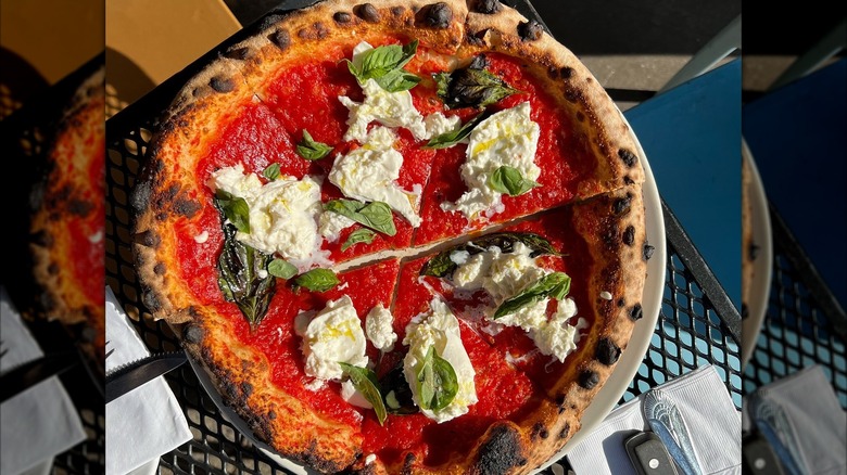 Margherita pizza on black iron table