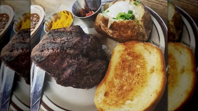 Jocko's filet mignin with sides of loaded baked potato and texas toast