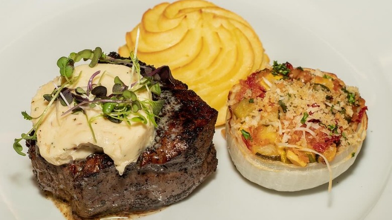 Steak with potato on plate at Scotch and Sirloin