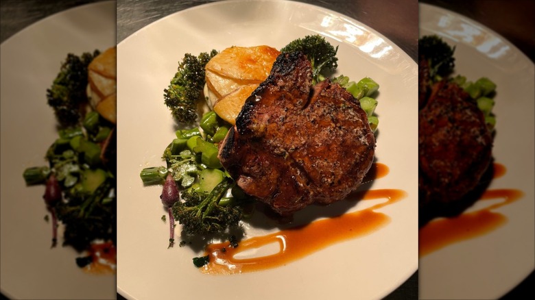 Steak with veggies on plate at Le Moo