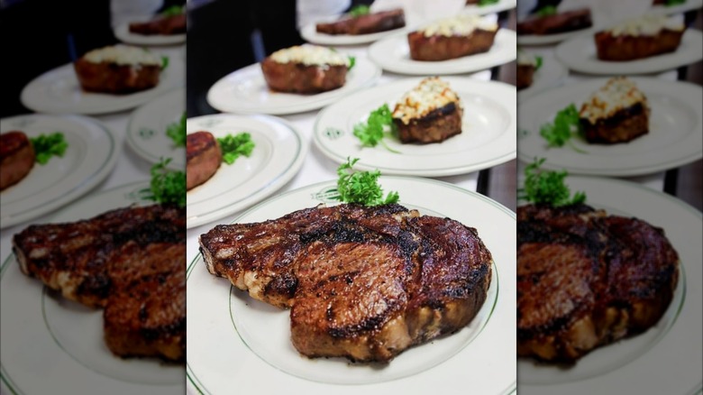 plated steaks and baked potatoes ready to serve at Manny's